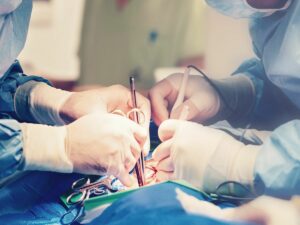 Surgeons work on a patient who had to choose between local anesthesia vs iv sedation