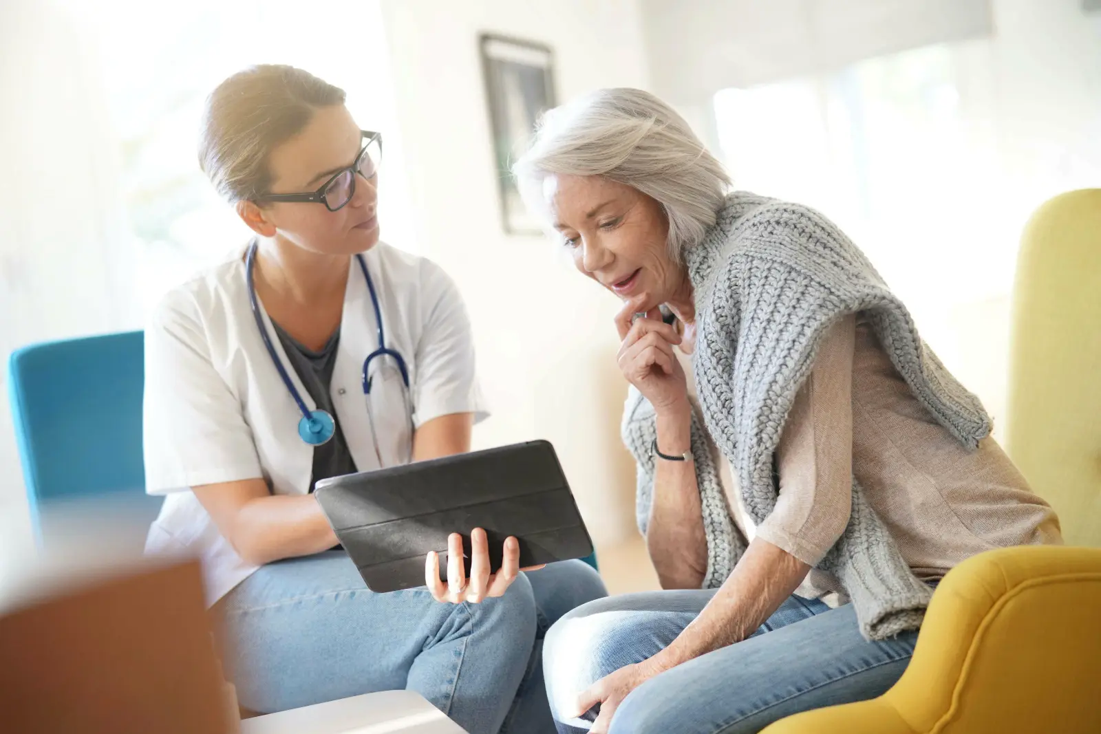 Doctor going through results and medication on tablet with senior patient. specialist Surgical Care