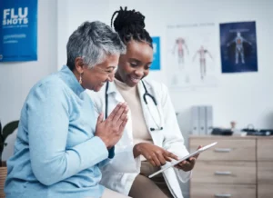 Black woman, doctor and senior patient with tablet, results and happy for health clearance, advice or report. Budget-Friendly Outpatient Surgery Centers