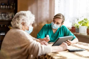 Affordable Specialists. Home caregiver helping senior woman with medication