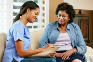 Affordable Personalized Surgical Care. Nurse Making Notes During Home Visit With Senior Female Patient