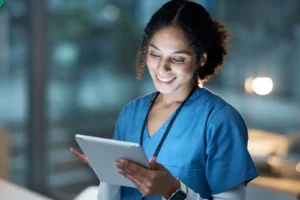 Outpatient Surgeries. Nurse medical tablet and woman in hospital working late